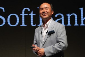 Photo of Masayoshi Son standing in front of the word 'SoftBank'.